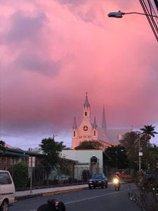 Pink clouds over a Costa Rican city scape