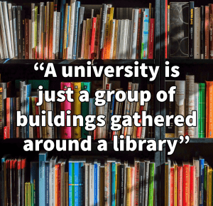 A wall of bookshelves with the text: "A university is just a group of buildings gathered around a library"