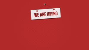 White sign on red background with text: "We are hiring"